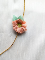 Peach kasuti rakhi with delicate hand embroidery